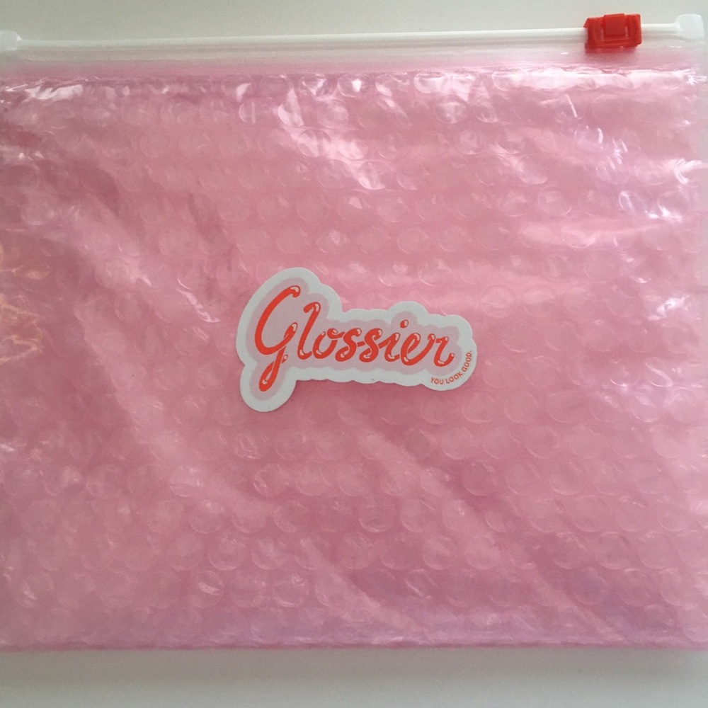 Glossier sticker and pouch